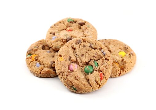 Round shortbread cookies with multicolored chocolate chips on white background. Sweet for kids.