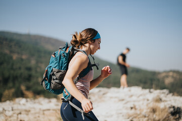 Active woman enjoying a sunny day hiking through the green forest and mountain landscape wearing sportswear, provides a healthy workout and outdoor adventure on her day off.