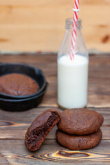 Fresh homemade chocolate chip cookies in an iron skillet on a wooden rustic background