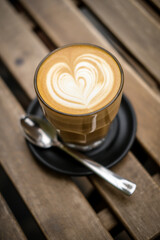 Speciality coffee cup with art latte depicting a heart