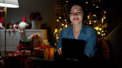 Young caucasian woman using tablet sitting on the sofa at home