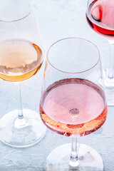 Wine glasses at a tasting. Rose, red, and white wine, drinks on a table at a winery. Different colors of wine