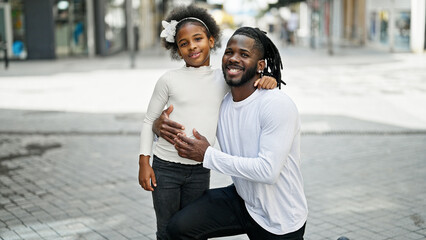 Fototapeta premium African american father and daughter smiling confident hugging each other at street