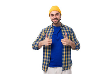 young stylish brunette man with a beard and mustache in a shirt and hat shows like