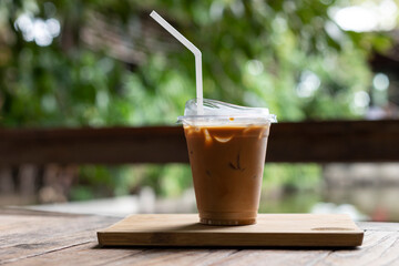 ice coffee in the take away plastic cup in garden