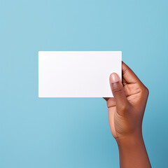 Woman hand holding blank business card on blue background, mockup.