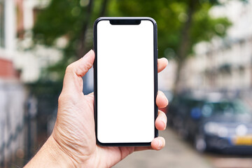 Man holding smartphone showing white blank screen at street