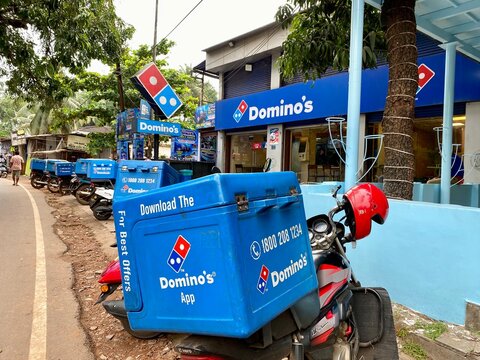 Calangute, Goa, India - October 17 2023: Dominos Pizza delivery boxes on top of bikes outside a Dominos Pizza outlet in Goa.