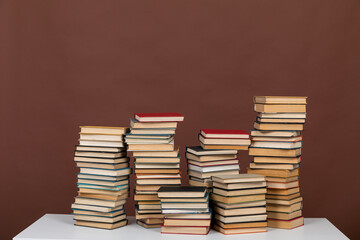 science learning library stack of books on brown background