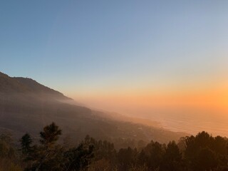 Sunset with the fog over the mountains and the ocean in O Baixo Miño, Galicia, Spain, February 2020