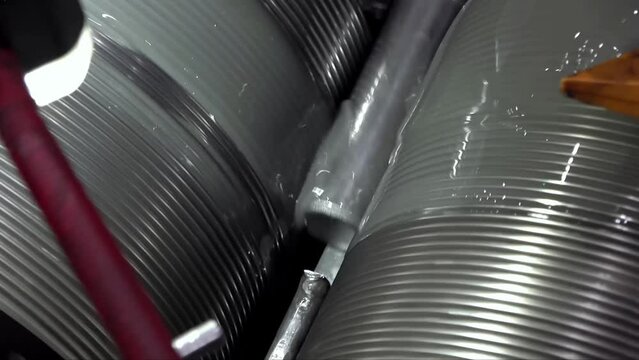 An overview of the process of manufacturing large-sized bolts and nuts in a factory using: blanks, metal saws, presses, ovens, and other.