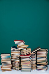 stack of books on a green background learning library learning science