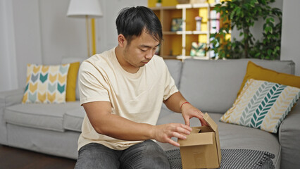  unpacking cardboard box at home