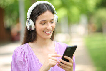 Happy woman listening to music on cell phone