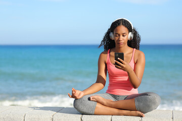 Fototapeta na wymiar Black yogi preparing yoga video guide