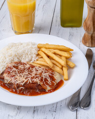 Parmegiana beef, rice and french fries. Typical brazilian executive dish