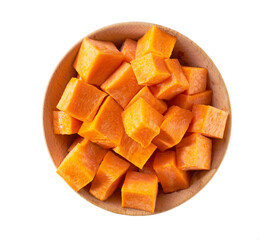dice carrots in a wooden bowl isolated on white background, top view.