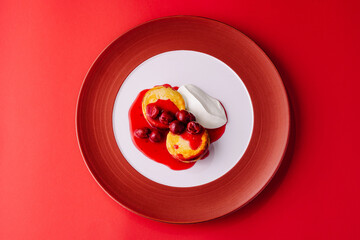 Cottage cheese pancakes with berry jam and sour cream