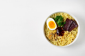 A bowl of Korean soup. Japanese ramen noodles with chicken, boiled egg, mushrooms, spring onions and soy sauce. Traditional Asian cuisine. copy space. top view