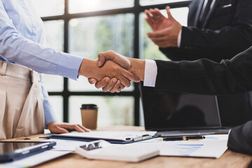 Businessmen shaking hands at a meeting of business partners.