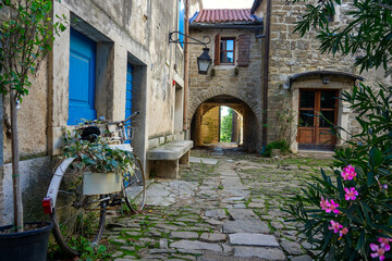 charming little village in Croatia called the istrian Toscana with stone walls and nice doors and windows - obrazy, fototapety, plakaty