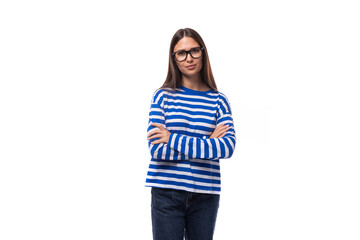 portrait of a young female student european brunette young lady in a blue blouse and jeans on a white background