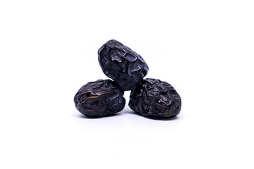 Creative layout made of three Ajwa dates fruits isolated on a white background. Ramadan Arabic food concept. Ajwa is a palm date that is widely grown in Medina and is good for health.