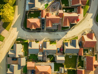 Drone top down view of an autumnal view of both private and affordable homes at a new housing...