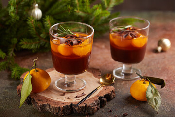 Jelly with tangerines and chocolate panna cotta. Layered Christmas dessert in glass.