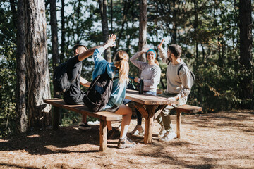 Active friends hiking in the forest, exploring the natural environment, having fun conversations and enjoying physical activity on a sunny day off.