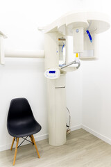 Vertical photo of a panoramic X-ray system room. Orthoanthograph. Dental equipment. Equipment for orthoanthomography. Creation of a panoramic photograph of the oral cavity. 3D dental tomograph.