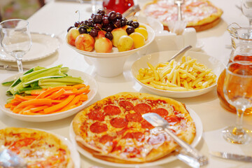 A table served for a children's party with children's favorite fast food. 