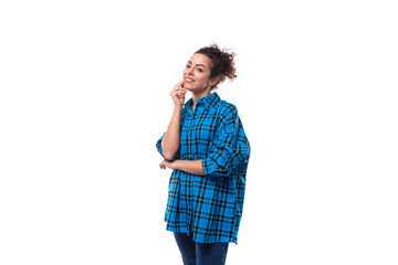 young pretty slender woman with careless curly hairstyle dressed in oversized casual shirt