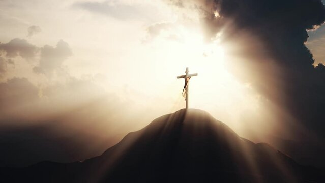 A bright ray of light shining through the sky and passing clouds, and a silhouette of the holy cross symbolizing the passion, suffering, death, and resurrection of Jesus Christ.
