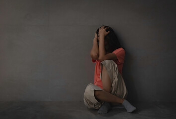 Unhappy woman sitting on ground floor,feeling tried and upset,mental disease,