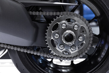 closeup motorcycle chain gear rear wheel for big bike high speed performance clean new.