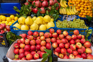 Fruit stand , apples, pomegranate, grapes, bananas