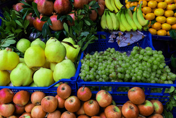 Fruit stand , apples, pomegranate, grapes, bananas