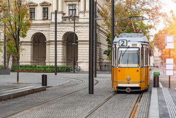 Naklejka premium Yellow tram in Budapest, Hungary. Yellow tram in Budapest goes from all the historical attractions of the city.