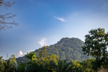 Tall mountains and clear skies, high clouds, true nature in the natural forest.