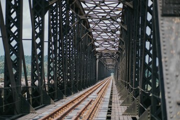 Tall steel bridge with a railway over the river