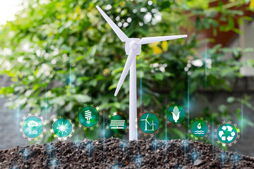 Green energy, eco energy concept. Light bulb is located on the soil, and plant are growing with wind turbine. Renewable energy generation is essential in the future. - obrazy, fototapety, plakaty
