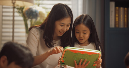 Close Up Portrait of a Mother and Daughter Using Digital Tablet at Home. Mom with Her Cute Little...