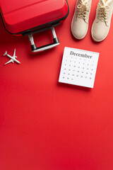 Holiday Adventure Awaits: top view vertical shot featuring female winter boots, suitcase, small...