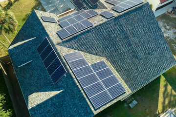 Aerial view of american building roof with blue solar photovoltaic panels for producing clean...