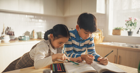 Kids in the Kitchen at Home: Cute Korean Children Are Coloring and Doing Homework While Waiting for...