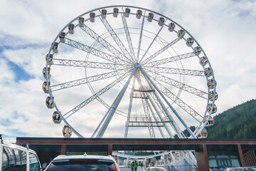 Big tall white ferris wheel in front of perfect blue sky in Bukovel. Carpathians Ukraine