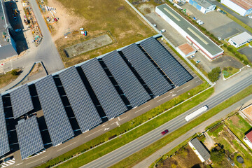 Aerial view of solar panels installed as shade roof over parking lot with parked cars for effective...