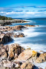 East Coast Long Exposure coastal picture with crashing waves on rocky headlands in Newfoundland and Labrador Canada.