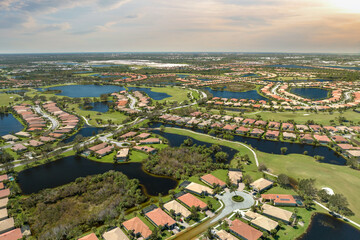 Naklejka premium Heavy flood with high water surrounding residential houses after hurricane Ian rainfall in Florida residential area. Consequences of natural disaster